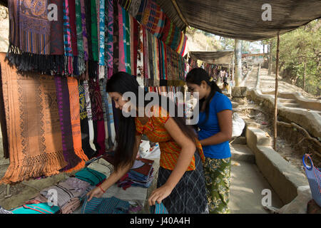 Ethnic girls selling traditional fabrics at Moheskhali Island. Cox’s Bazar, Bangladesh. Stock Photo