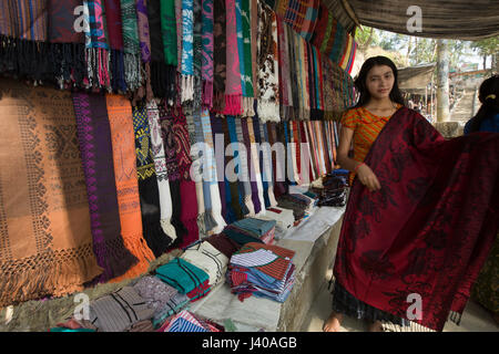 Ethnic girls selling traditional fabrics at Moheskhali Island. Cox’s Bazar, Bangladesh. Stock Photo