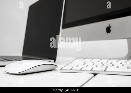 BELGRADE, SERBIA - MARCH 8, 2017: iMac computer and MacBook laptop on the table. iMac is a range of all-in-one Macintosh desktop computers designed an Stock Photo