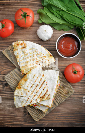 Stack of mexican Quesadilla with chicken, corn, sweet pepper and tomato.  Top view Stock Photo