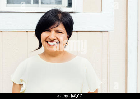 Portrait of woman looking at camera smiling Stock Photo