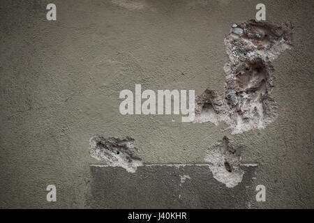 Damaged plaster on the wall of a building. Stock Photo
