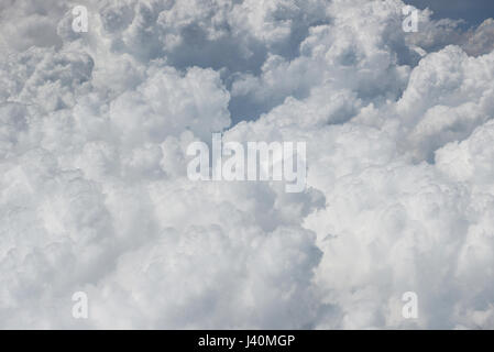 Fluffy white clouds top view. Big cloud view from airplane Stock Photo