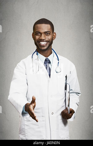 Closeup portrait smiling healthcare professional, male doctor with stethoscope, holding clipboard giving handshake isolated black background. Patient  Stock Photo
