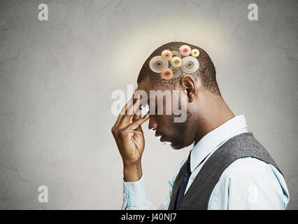 Closeup side view profile headshot thoughtful man, young guy thinking hard, gear mechanism, illustration over head isolated grey wall background. Huma Stock Photo