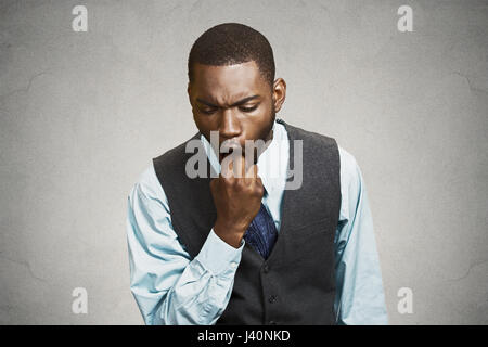 Closeup portrait young business man sticking finger in mouth about to throw up show disgust displeasure with situation something sucks isolated black  Stock Photo