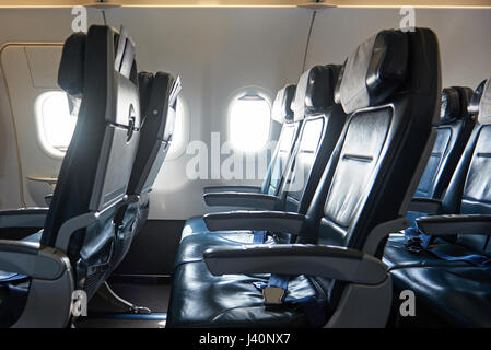 Comfortable leather seats in airplane. Clean aircraft cabin Stock Photo