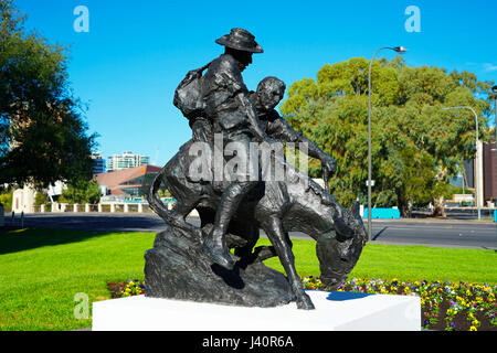 ADELAIDE, SOUTH AUSTRALIA - APRIL 28, 2017: The legendary Simpson and his donkey ANZAC memorial statue situated in the northern parklands with city sk Stock Photo