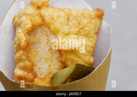 Shrimps, potatoes and vegetables in batter, fried . Street food in cardboard package. Stock Photo