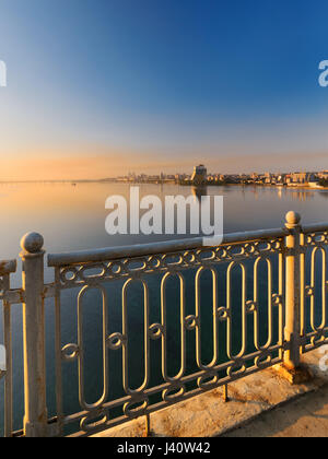 Beautiful view from the bridge to the city at dawn in the rays of the rising sun. Dnepropetrovsk, Ukraine Stock Photo