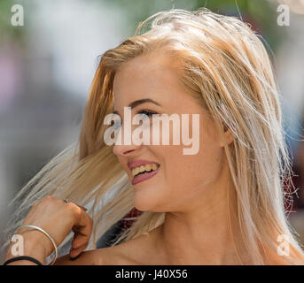 smiling attractive girl, styling hair Stock Photo