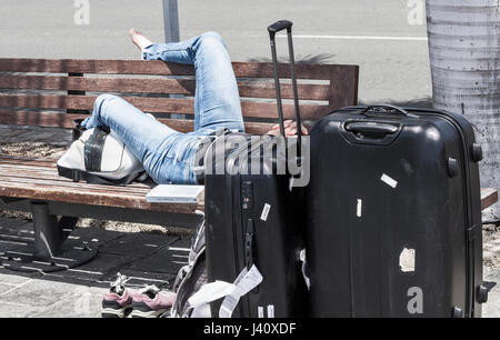 Female tourist with large wheeled suitcases: flight delayed, cancelled...concept image. Stock Photo