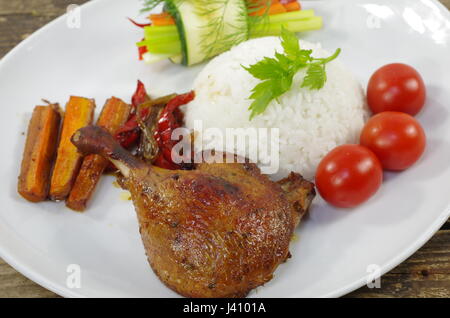 roast leg duck with rice on white plate Stock Photo