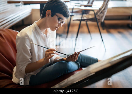 Creative pensive art school painter working on painting project Stock Photo