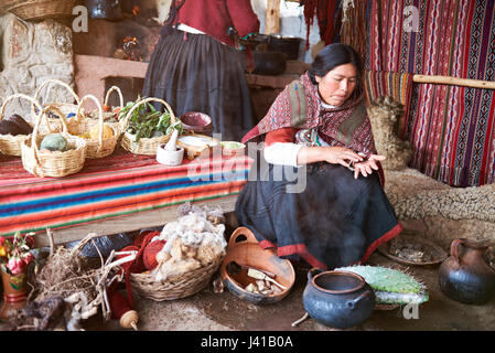 Cusco,  Peru - April 21, 2017: Traditional alpaca handmade factory in Peru. Woman working on alpaca clothes Stock Photo