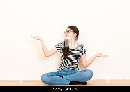 Portrait dumb looking woman arms out shrugs shoulders isolated on white blank background. Negative human emotion, facial expression body language life Stock Photo