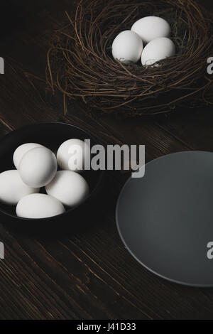 Easter eggs and bird nest on a rustic wooden table Stock Photo