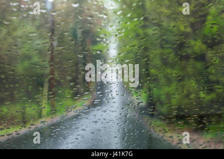 Driving on a country road in the rain Stock Photo