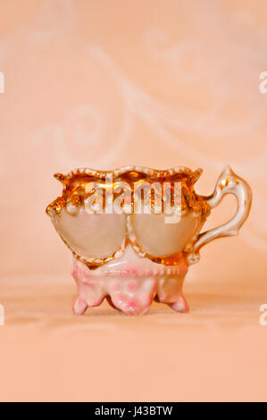 Vintage porcelain tea cup with gold painted trim Stock Photo