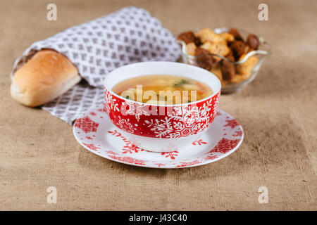 Fresh pea soup with meat in white bowl over rustic wooden background Stock Photo