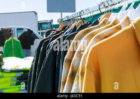 Selective focus some used leather clothes hanging on a rack in market Stock Photo