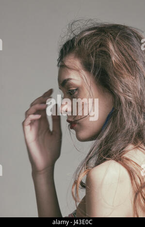 Serious young woman looking away Stock Photo