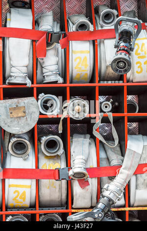 compartment of rolled up fire hoses on a fire truck Stock Photo