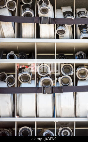 compartment of rolled up fire hoses on a fire engine Stock Photo