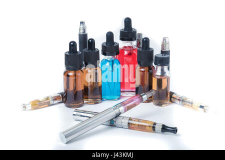 Thin e-cigarettes with glass bottles on white background Stock Photo