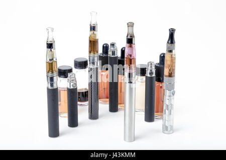 Thin e-cigarettes with glass bottles on white background Stock Photo