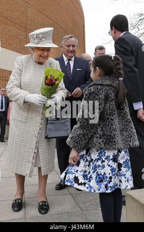 Queen Elizabeth II is accompanied by Chair of Governors, Roger Laneknott (second left) during a visit to Pangbourne College in Berkshire to celebrate its centenary. Stock Photo