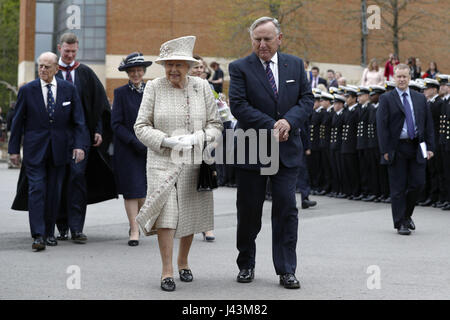 Queen Elizabeth II accompanied by Chair of Governors, Roger Laneknott during a visit to Pangbourne College in Berkshire to celebrate its centenary. Stock Photo