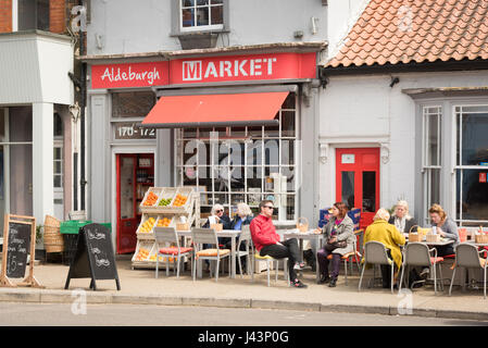 Aldeburgh Market cafe, delicatessen in Aldeburgh Suffolk UK with people eating outside at tables and chairs al fresco Stock Photo