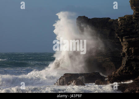 Stormy Wave Crashing against Rocks Stock Photo