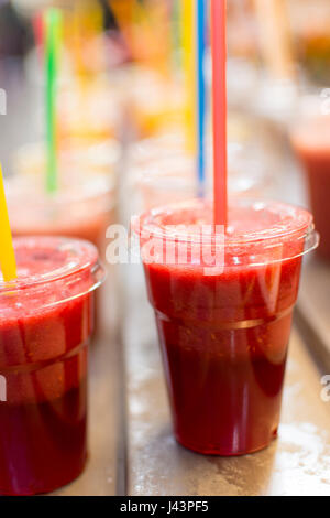 Freshly Squeezed Fruit Cocktail Juices with Colorful Straws Stock Photo