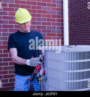 HVAC Technician Repairing Air Conditioning Stock Photo
