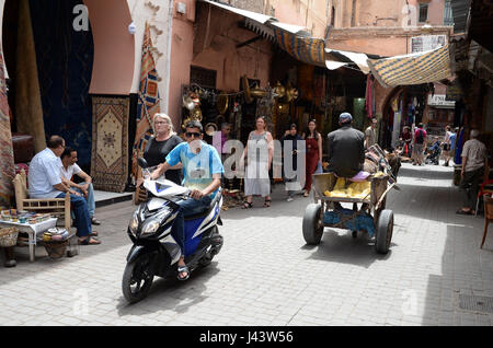 Marrakesh, Morocco. 21st Apr, 2017. A young man on a moped and an old man on a donkey cart can be seen at a Souk bazar in Marrakesh, Morocco, 21 April 2017. Photo: Jens Kalaene/dpa-Zentralbild/ZB/dpa/Alamy Live News Stock Photo