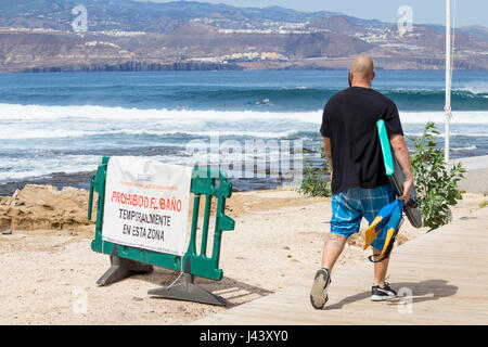 Las Palmas, Gran Canaria, Canary Islands, Spain, 9th May 2017. Surfers ignore swimming ban to surf huge waves at world renown surf break, El Confital, in Las Palmas, the capital of Gran Canaria. The swimming ban has been in place for two weeks due to higher than permitted levels of Enterococcus bacteria. Credit: ALAN DAWSON/Alamy Live News Stock Photo