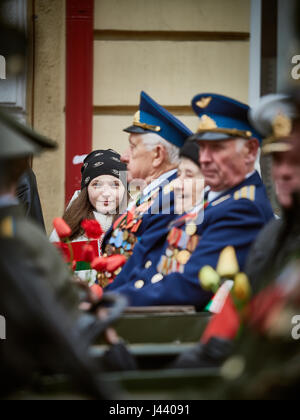 Vitebsk, Belarus. 9th May, 2017. The procession along the main street of the city. Participate in as the veterans of the great Patriotic war and young generation of Vitebsk. People give flowers to the elderly and lay wreaths at the monument 'Eternal Fire'. Credit: Alexey Vronsky/Alamy Live News Stock Photo