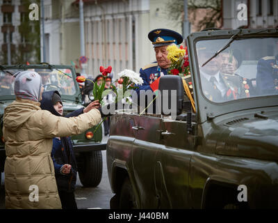 Vitebsk, Belarus. 9th May, 2017. The procession along the main street of the city. Participate in as the veterans of the great Patriotic war and young generation of Vitebsk. People give flowers to the elderly and lay wreaths at the monument 'Eternal Fire'. Credit: Alexey Vronsky/Alamy Live News Stock Photo