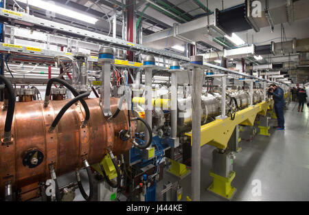 Geneva, Switzerland. 9th May, 2017. People visit the Linac 4 linear accelerator at the European Organization for Nuclear Research (CERN) in Meyrin near Geneva, Switzerland, on May 9, 2017. Scientists at the CERN inaugurated Tuesday the linear accelerator Linac 4, the newest accelerator acquisition since the Large Hadron Collider (LHC). Linac 4 is due to feed the CERN accelerator complex with particle beams of higher energy, which will allow the LHC to reach higher luminosity by 2021. Credit: Xu Jinquan/Xinhua/Alamy Live News Stock Photo