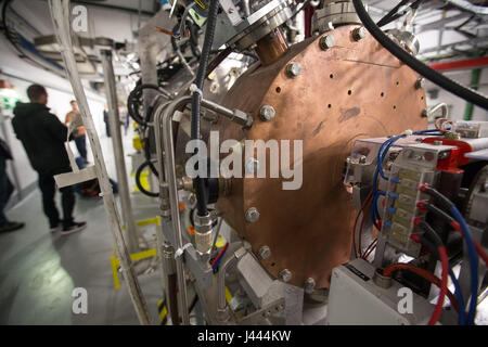 Geneva, Switzerland. 9th May, 2017. People visit the Linac 4 linear accelerator at the European Organization for Nuclear Research (CERN) in Meyrin near Geneva, Switzerland, on May 9, 2017. Scientists at the CERN inaugurated Tuesday the linear accelerator Linac 4, the newest accelerator acquisition since the Large Hadron Collider (LHC). Linac 4 is due to feed the CERN accelerator complex with particle beams of higher energy, which will allow the LHC to reach higher luminosity by 2021. Credit: Xu Jinquan/Xinhua/Alamy Live News Stock Photo