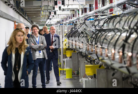 Geneva, Switzerland. 9th May, 2017. People visit the Linac 4 linear accelerator at the European Organization for Nuclear Research (CERN) in Meyrin near Geneva, Switzerland, on May 9, 2017. Scientists at the CERN inaugurated Tuesday the linear accelerator Linac 4, the newest accelerator acquisition since the Large Hadron Collider (LHC). Linac 4 is due to feed the CERN accelerator complex with particle beams of higher energy, which will allow the LHC to reach higher luminosity by 2021. Credit: Xu Jinquan/Xinhua/Alamy Live News Stock Photo