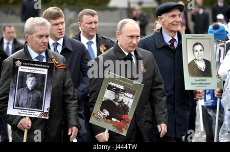 Moscow, Russia. 9th May, 2017. Russian President Vladimir Putin, holds a portrait of his war veteran father Vladimir Spiridonovich Putin, during the Immortal Regiment patriotic march marking the annual Victory Day celebrations and the 72nd anniversary of the end of World War II in Red Square May 9, 2017 in Moscow, Russia. Credit: Planetpix/Alamy Live News Stock Photo