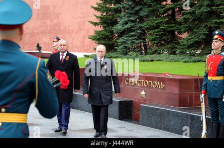 Moscow, Russia. 9th May, 2017. Russian President Vladimir Putin, right, and Moldovan President Igor Dodan, left, place flowers at the Tomb of the Unknown Soldier during the annual Victory Day celebrations marking the 72nd anniversary of the end of World War II in Red Square May 9, 2017 in Moscow, Russia. Credit: Planetpix/Alamy Live News Stock Photo