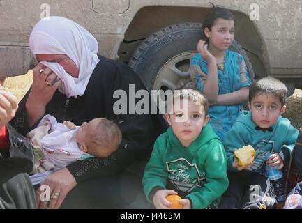 Mosul, Iraq. 9th May, 2017. A woman weeps on the way fleeing the western part of Mosul, the second largest city of Iraq, on May 9, 2017. Iraqi forces battling IS militants on Tuesday extended grip into northern Mosul on the sixth day of a new push that initiated a new front in the northwestern edge of IS stronghold in the western side of Mosul, the Iraqi military said. Credit: Cheng Shuaipeng/Xinhua/Alamy Live News Stock Photo