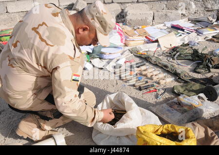 Mosul, Iraq. 9th May, 2017. An Iraqi soldier checks the seized arms and ammunition in the northwestern suburb of Mosul, Iraq, May 9, 2017. Credit: Wei Yudong/Xinhua/Alamy Live News Stock Photo