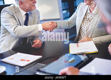 Close up of business couple shaking hands Stock Photo