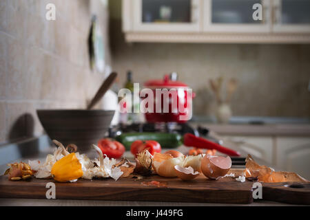 Food leftovers on kitchen counter. Household waste from vegetable ready to compost. Environmentally responsible behavior, ecology concept. Stock Photo