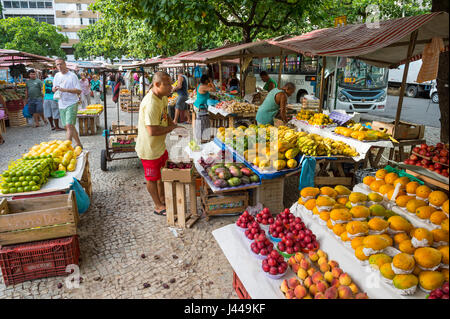 RIO DE JANEIRO - JANUARY 31, 2017: Tropical fruits and vegetables wait for customers browsing the weekly farmer's market in Ipanema. Stock Photo